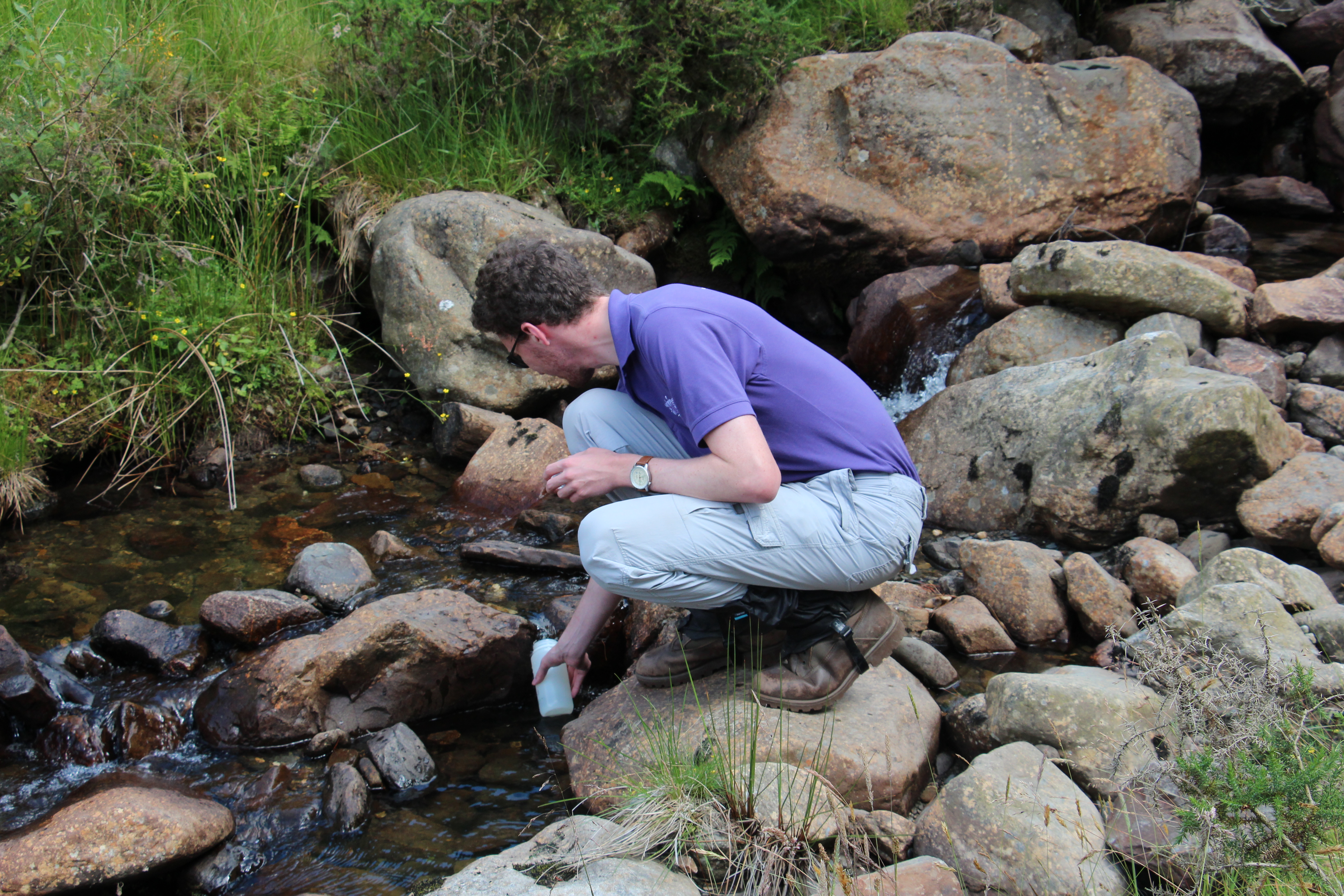 Aaron Todd collecting river samples
